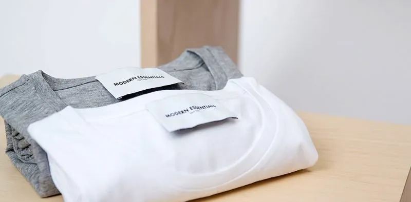 Folded T-shirts on a wooden table