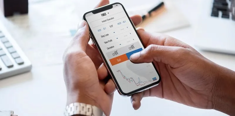 Hands using a smartphone app at a desk